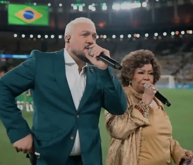 1 de 1 Alcione e Belo são detonados após cantar hino nacional em amistoso da Seleção - Foto: Reprodução/SporTV